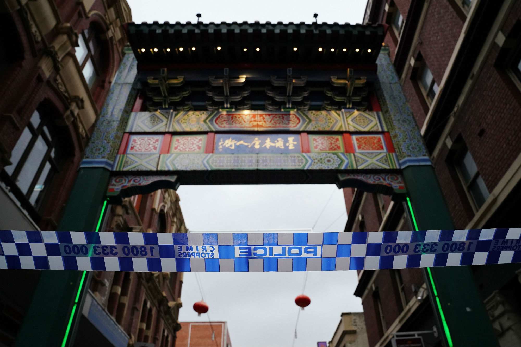The arch marking the entrance to Melbourne's Chinatown is shown behind police tape.