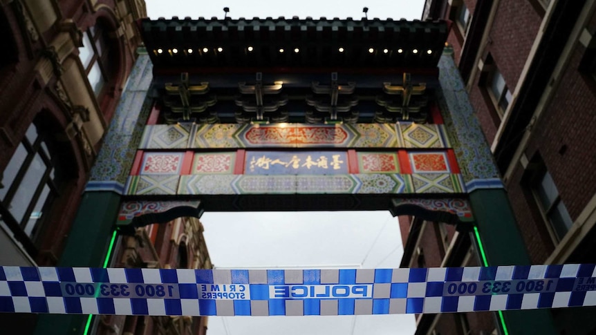 The arch marking the entrance to Melbourne's Chinatown is shown behind police tape.