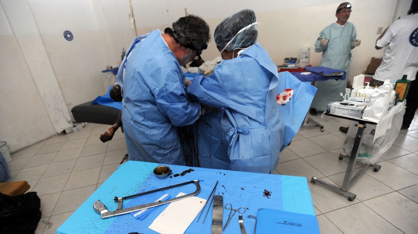 Doctors perform amputation in makeshift operating theatre in Haiti