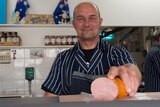Collinswood butcher Steve Howell holds one of South Australia's iconic Bung Fritz.