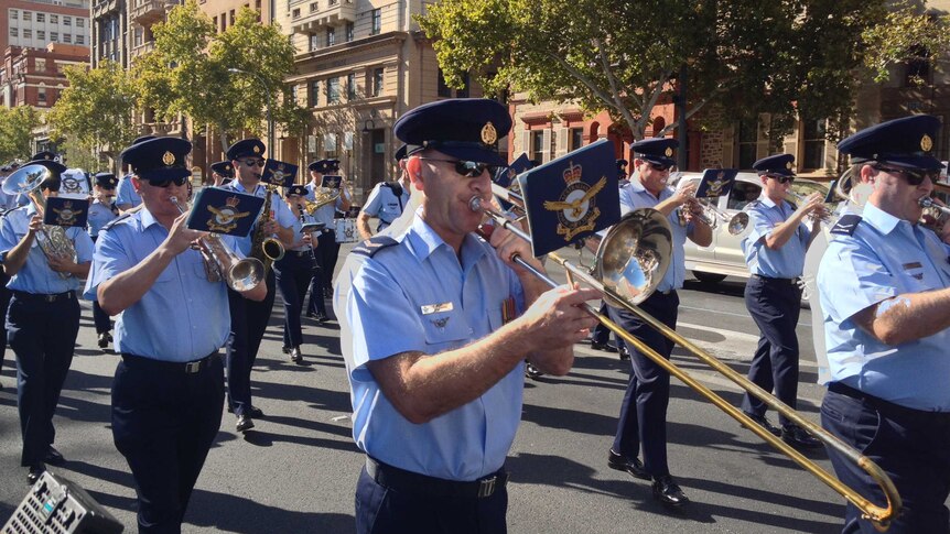 Defence personnel play instruments as they march in the Operation Slipper parade