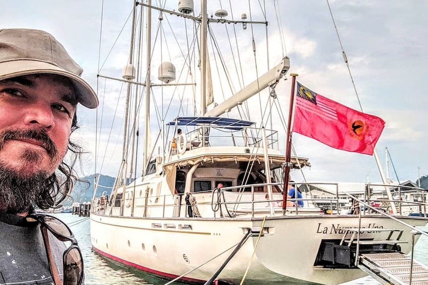 Man taking selfie near boat