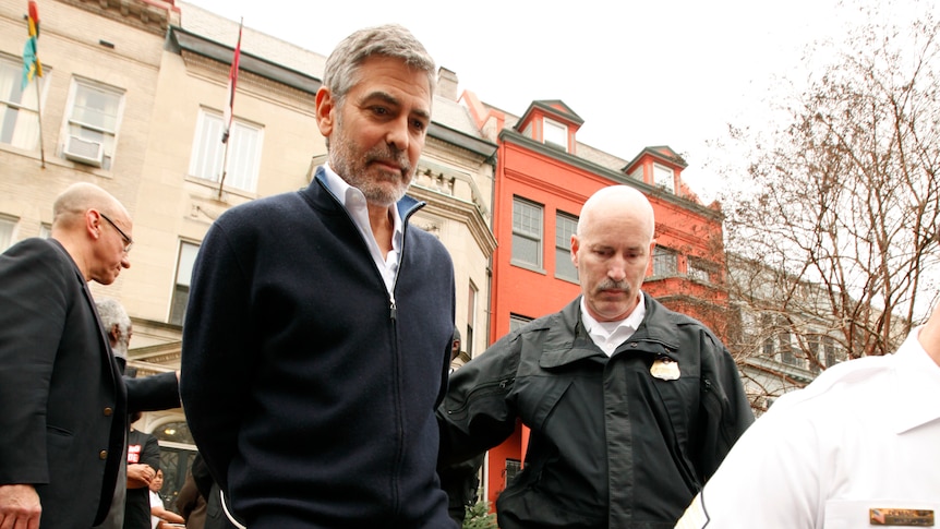 Actor George Clooney is arrested for civil disobedience after protesting at the Sudan Embassy in Washington