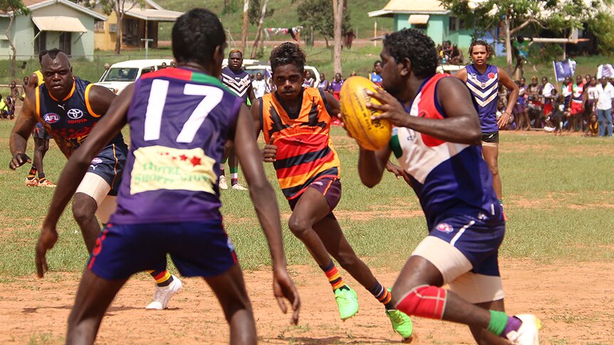 Footballers contesting the ball at the 2015 Wadeye Grand Final.