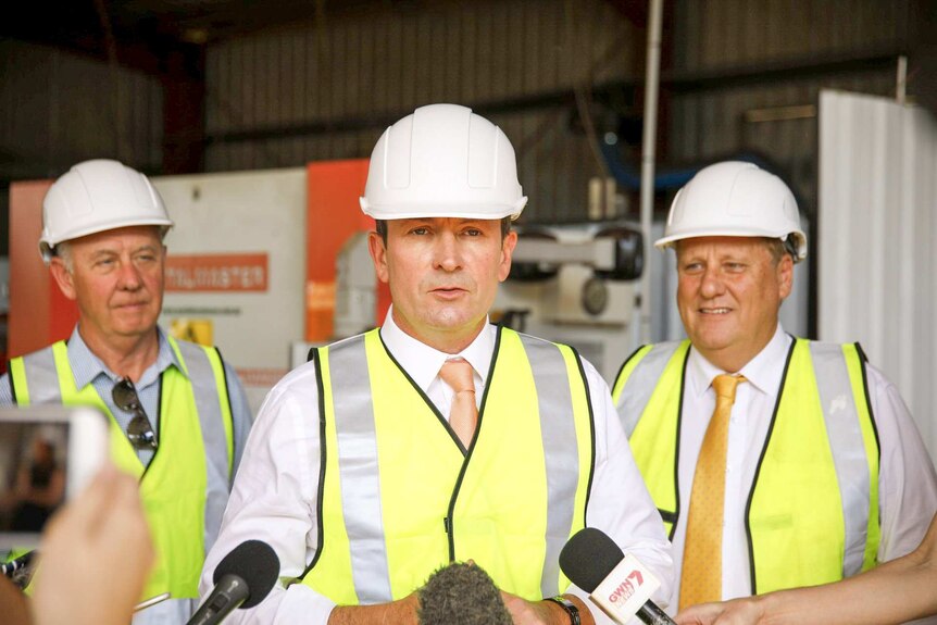 Mark McGowan wearing a hard hat and a high visibility vest.