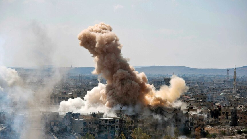 Smoke rises from southern Damascus, Syria.