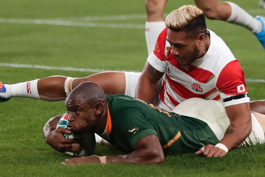 Makazole Mapimpi scores a try during the Rugby World Cup quarterfinal match at Tokyo Stadium between Japan