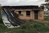 House with roof blown off.