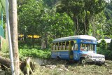 A bus lies on top of debris following the tsunami which struck Pago Pago