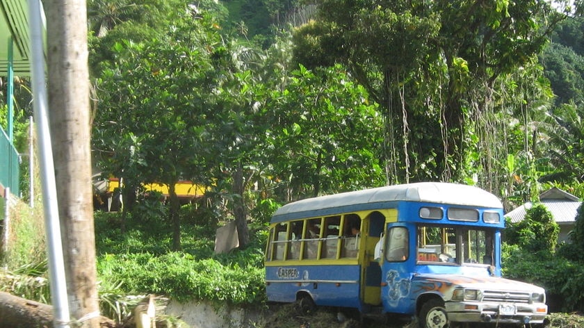 A bus lies on top of debris following the tsunami which struck Pago Pago