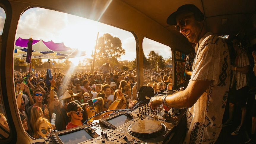 A DJ performs in front of a crowd
