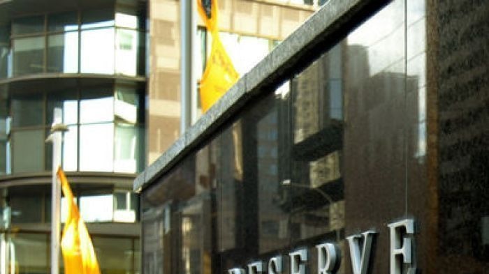 A woman passes by the Reserve Bank in Sydney.