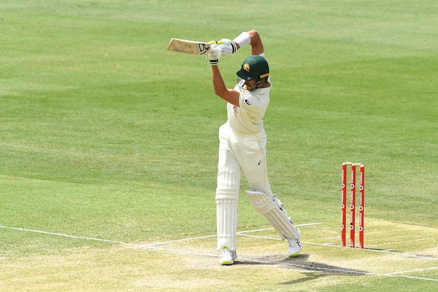 Australia batter Mitchell Starc plays a shot during the first Ashes Test at the Gabba.