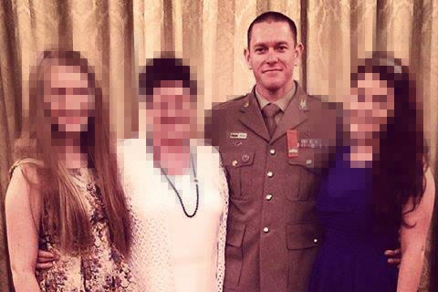 A man in military dress uniform is pictured with three women, whose faces are pixelated.