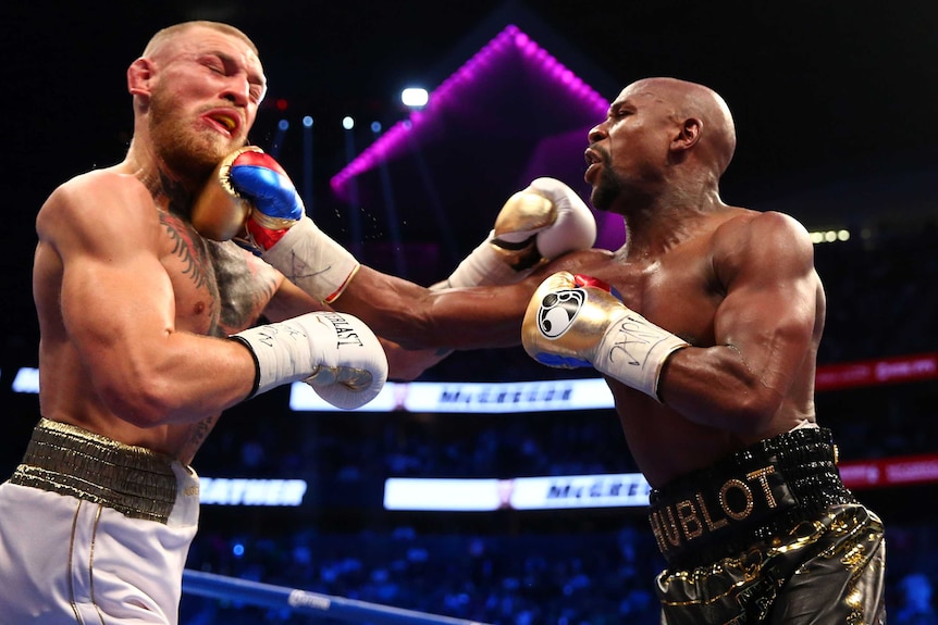 Floyd Mayweather lands a right hand on Conor McGregor