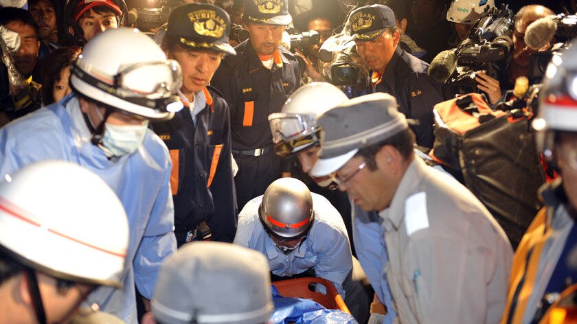 An earthquake victim is carried into an ambulance in Kurihara city, Japan.