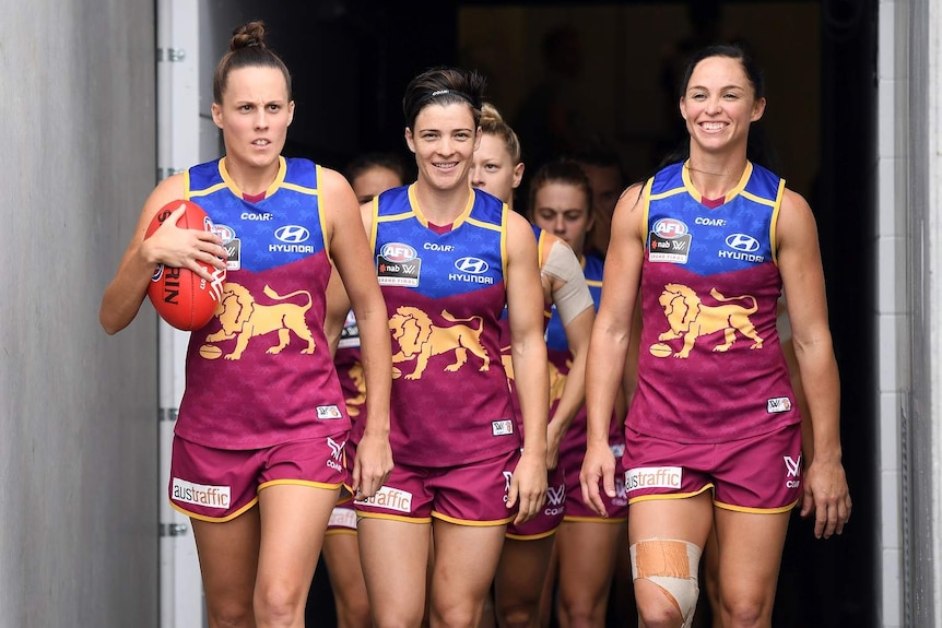 Brisbane Lions captain Emma Zielke leads the team onto the field for the AFLW Grand Final in 2017