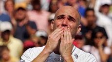 Andre Agassi blows kisses to the crowd after his defeat at the US Open