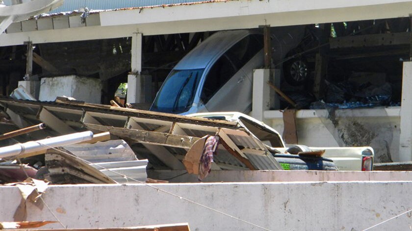 A car is seen inside a building after a tsunami hit the village of Si'umu in Western Samoa