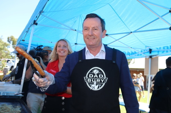 Mark McGowan with a sausage.