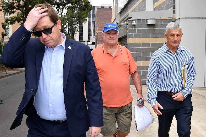 Troy Grant and Kenneth Grant leave court