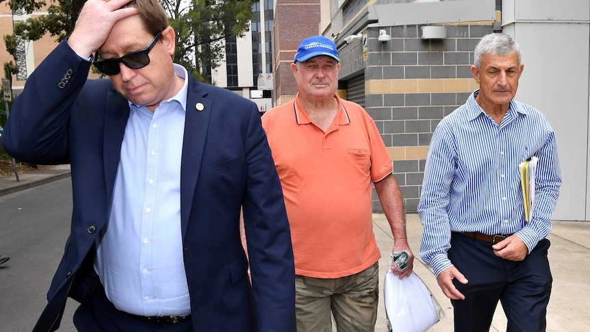 Troy Grant and Kenneth Grant leave court