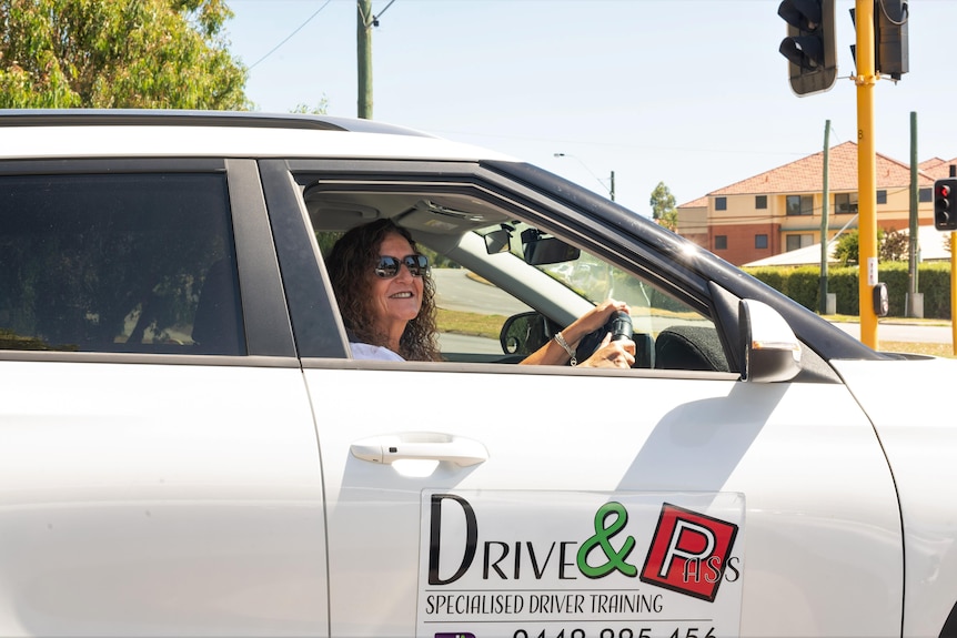 Ro Anne Steele behind the wheel of her car.