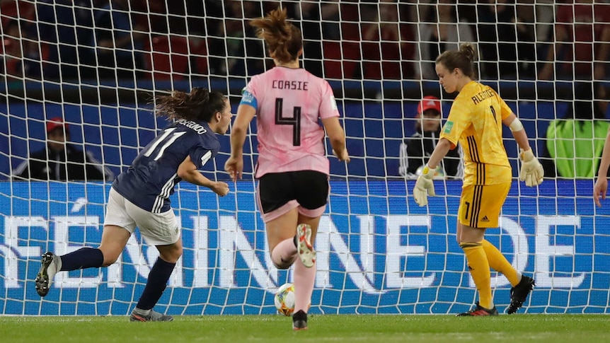 A soccer player wheels away in celebration after scoring a vital penalty at the Women's World Cup.