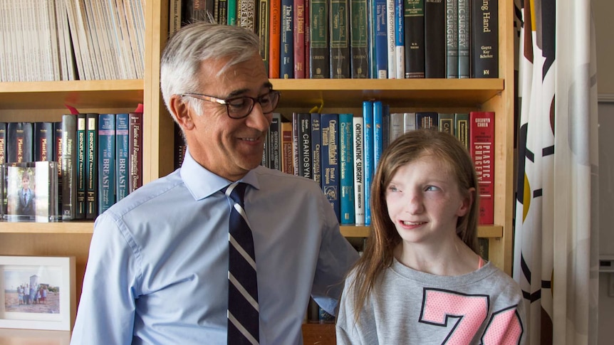 Dr Mark Gianoutsos standing with Stella Jackson in his surgery office