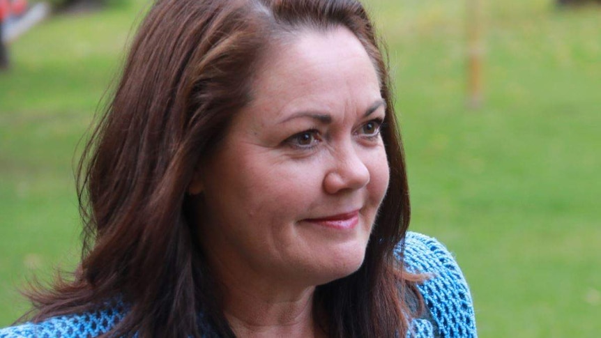 Liza Harvey smiles while standing outside Parliament.