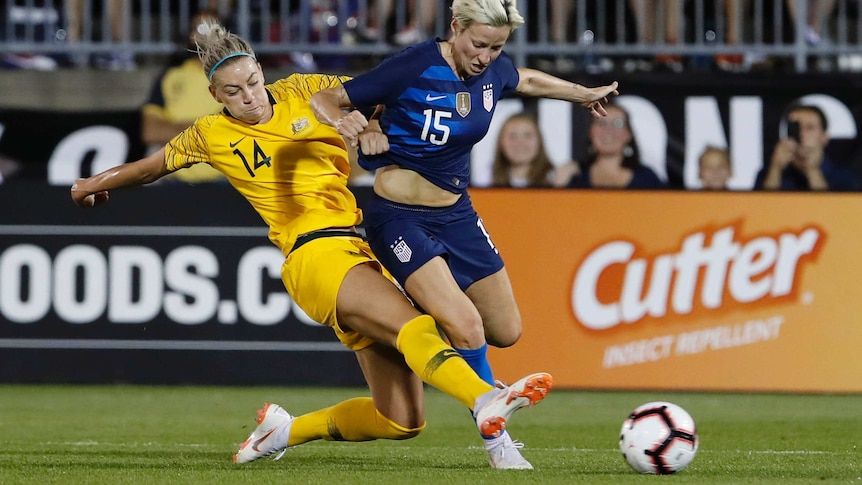 Matildas defender Alanna Kennedy tackles Megan Rapinoe in a match between Australia and USA in East Hartford in July 2018