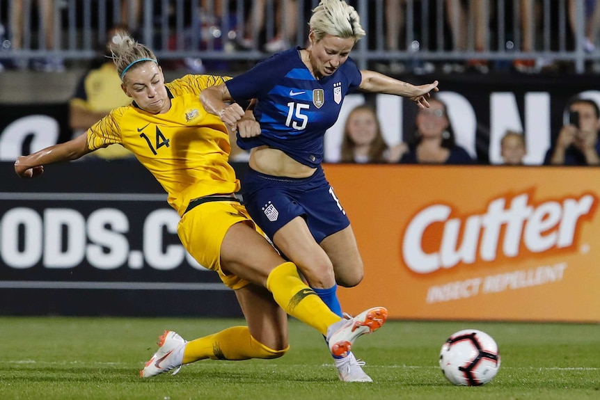 Matildas defender Alanna Kennedy tackles Megan Rapinoe in a match between Australia and USA in East Hartford in July 2018