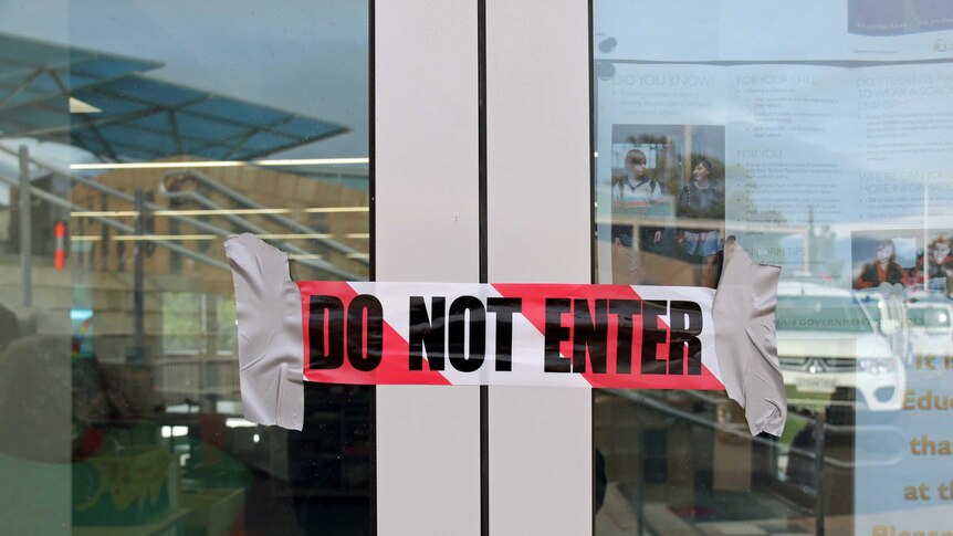 Do Not Enter tape over the doors at Dunalley Primary School.