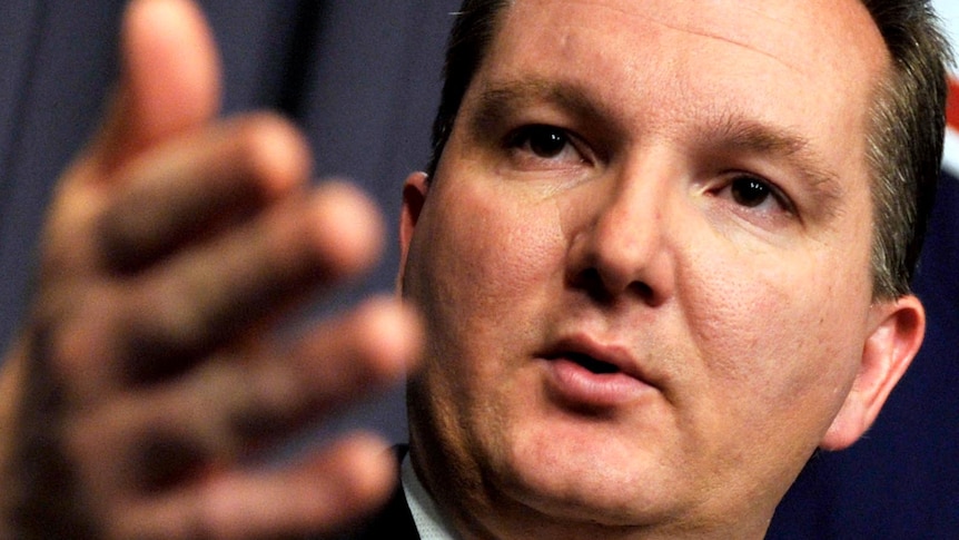 Chris Bowen gestures as he speaks during a press conference
