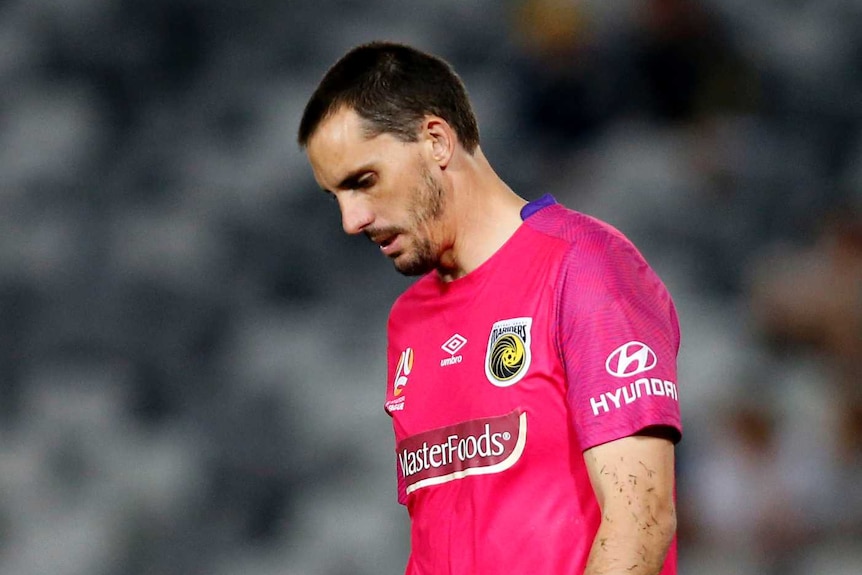 Central Coast Mariners goalkeeper Ben Kennedy walks with his head bowed during an 8-2 A-League loss against Wellington Phoenix.