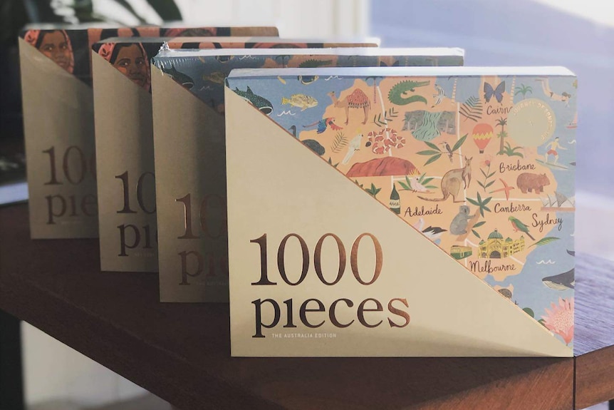 A photo of four Australian-themed puzzles on a wooden bench.