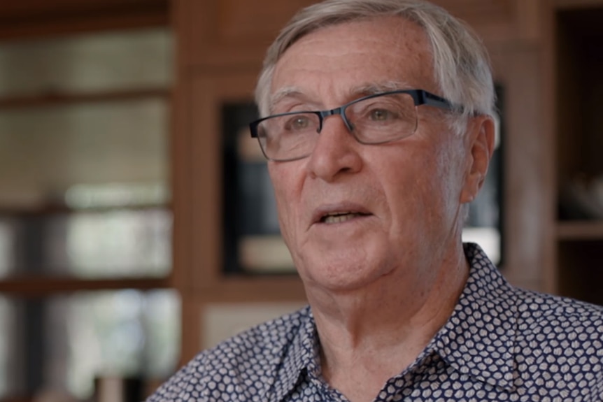 Close up of a man with grey hair and glasses