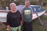 Reverend Toetu'u and his wife pose in front of their fishing boat. 