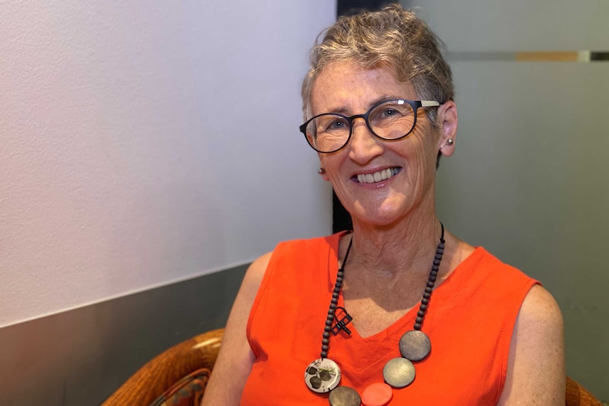 a 62yo woman in black rimmed eyeglasses.