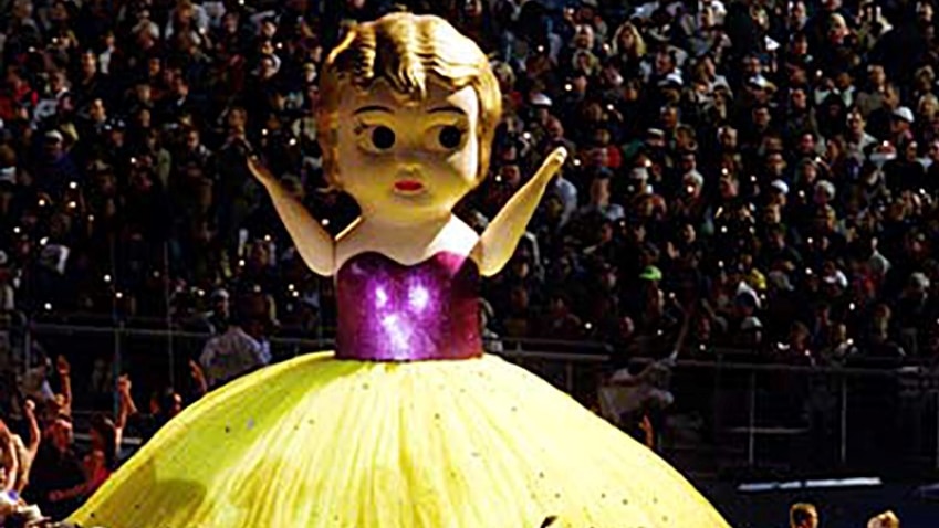 Giant kewpie doll in purple top and yellow skirt at the Sydney Olympics closing ceremony