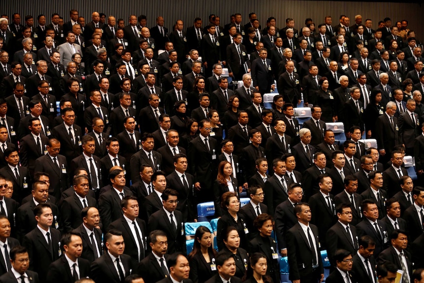 Men and women in stand in a huge room