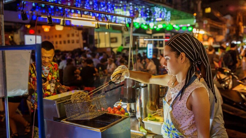 Thai woman makes street food