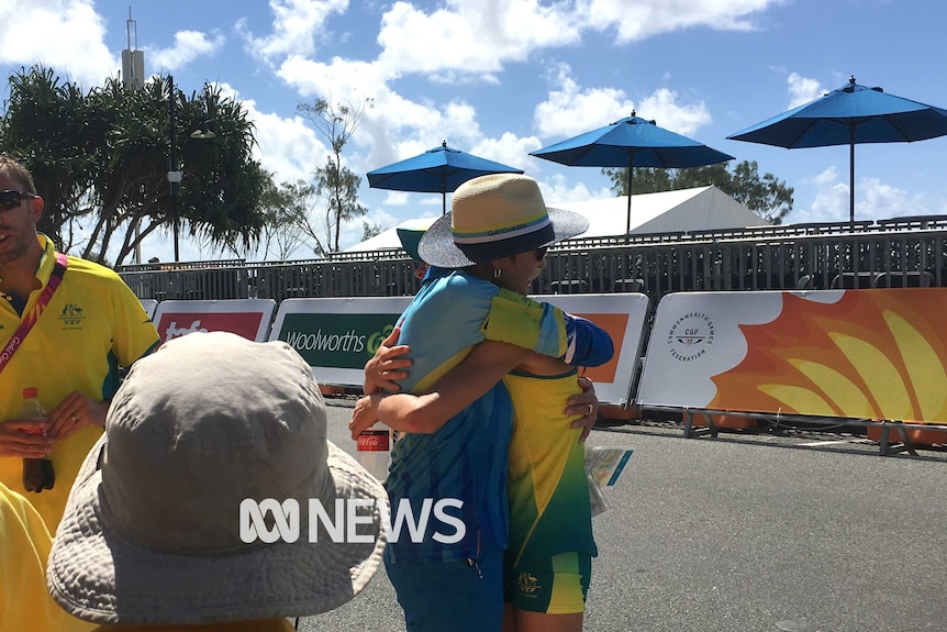 Claire Tallent hugs an official after being disqualified