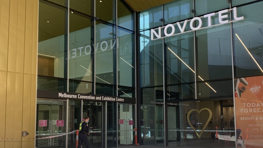 The Novotel hotel hotel in Melbourne, South Wharf, as a police officer walks towards the entrance.