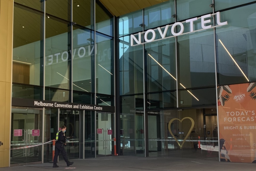 The Novotel hotel hotel in Melbourne, South Wharf, as a police officer walks towards the entrance.