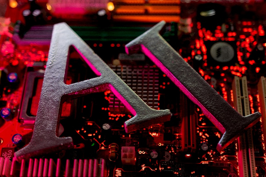 The letters A and I are placed over a red and black close up of computer chips.