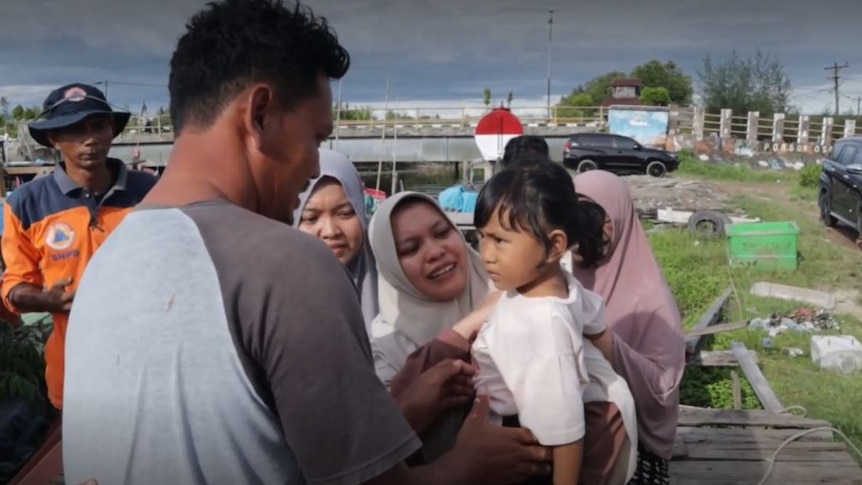 The captain of the missing boat, Yunardi Ardi, reunites with his family
