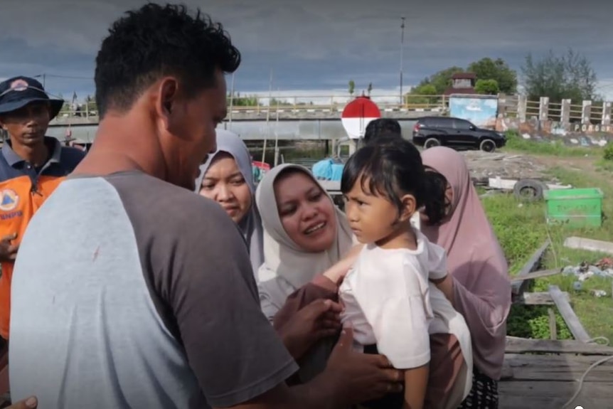 The captain of the missing boat, Yunardi Ardi, reunites with his family