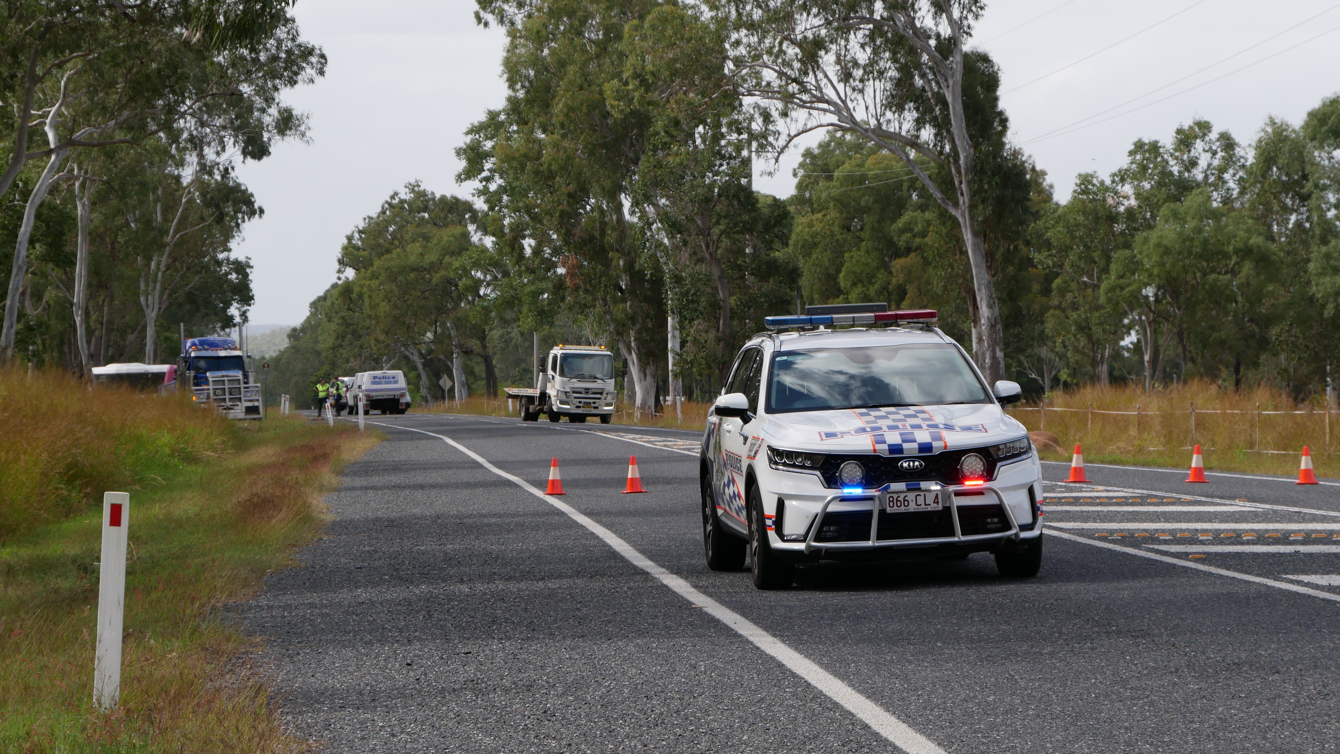 a police car in front of a road