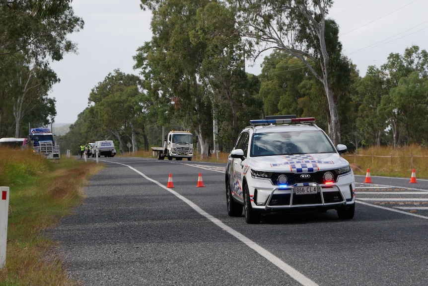 a police car in front of a road